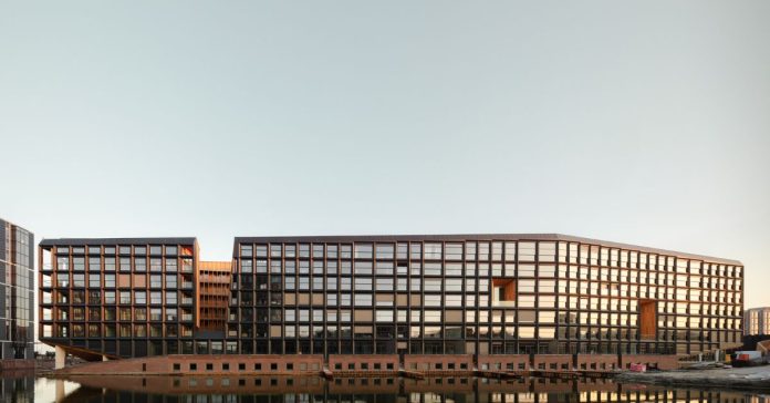 Modern building with zinc-inspired metallic cladding and reflective façade